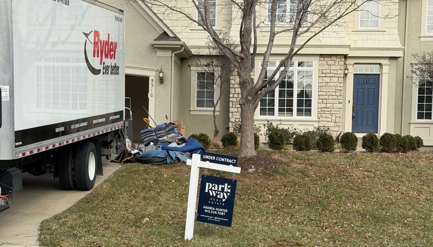 A God's Movers crew moving a large safe at a Kansas City area home