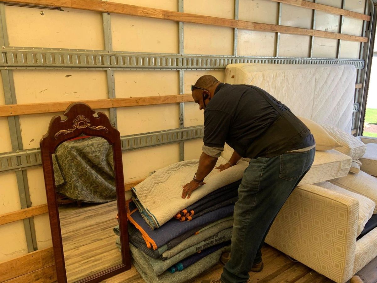 A God's Movers customer at home surrounded by packing boxes