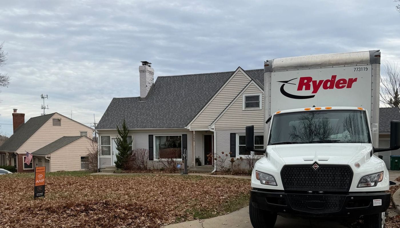 A God's Movers crew member delivering a mattress into a garage