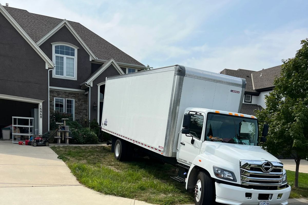 A loaded God's Movers truck with the ramp down