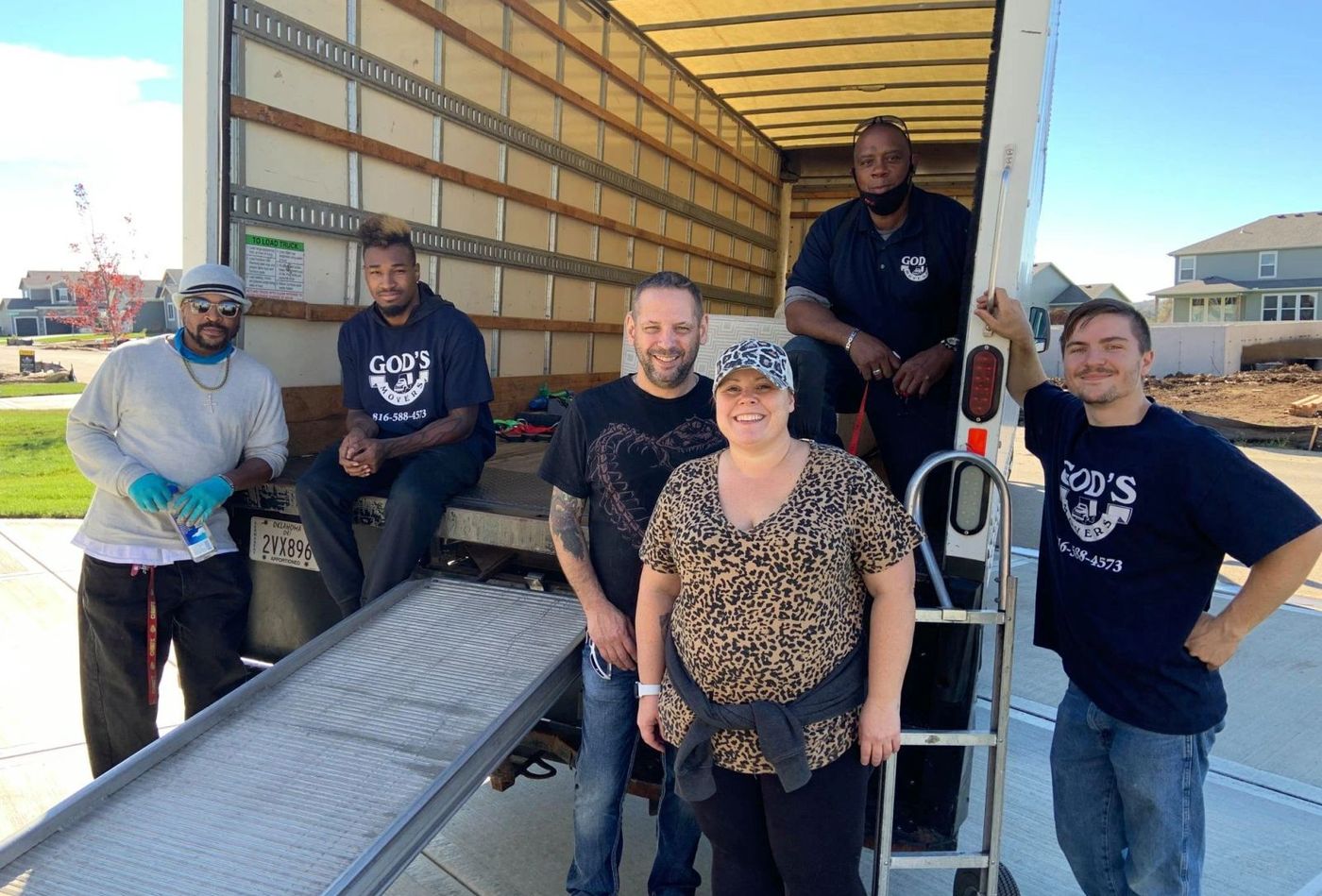 A God's Movers crew member padding and wrapping furniture in the truck