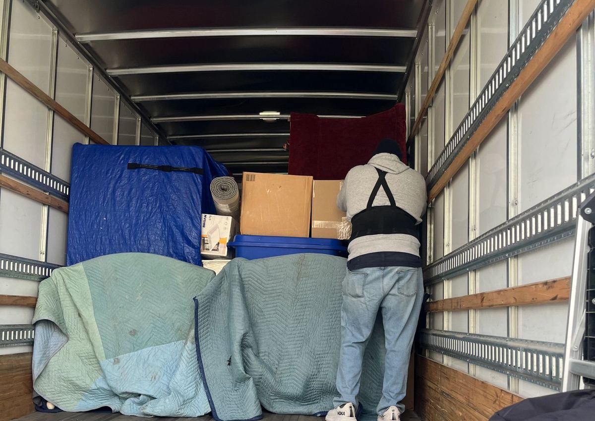A God's Movers truck on a residential street